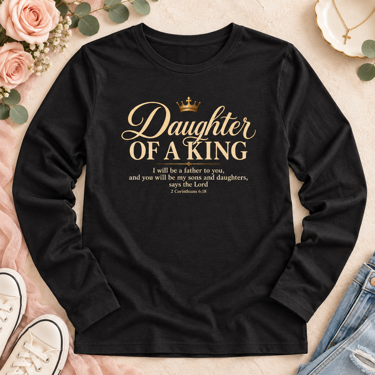 Black long-sleeve shirt with gold “Daughter of a King” lettering, a crown, and 2 Corinthians 6:18.