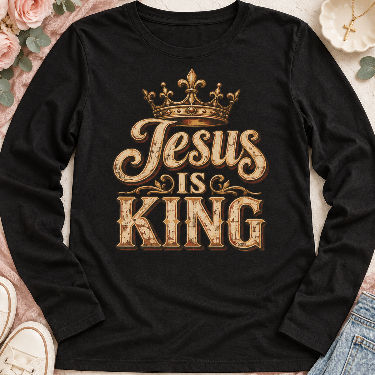 Black long-sleeve shirt with distressed gold “Jesus Is King” lettering and a crown.