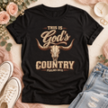 Black T-shirt with “This Is God’s Country” in distressed tan and brown lettering, a longhorn skull, and Psalms 50:11.
