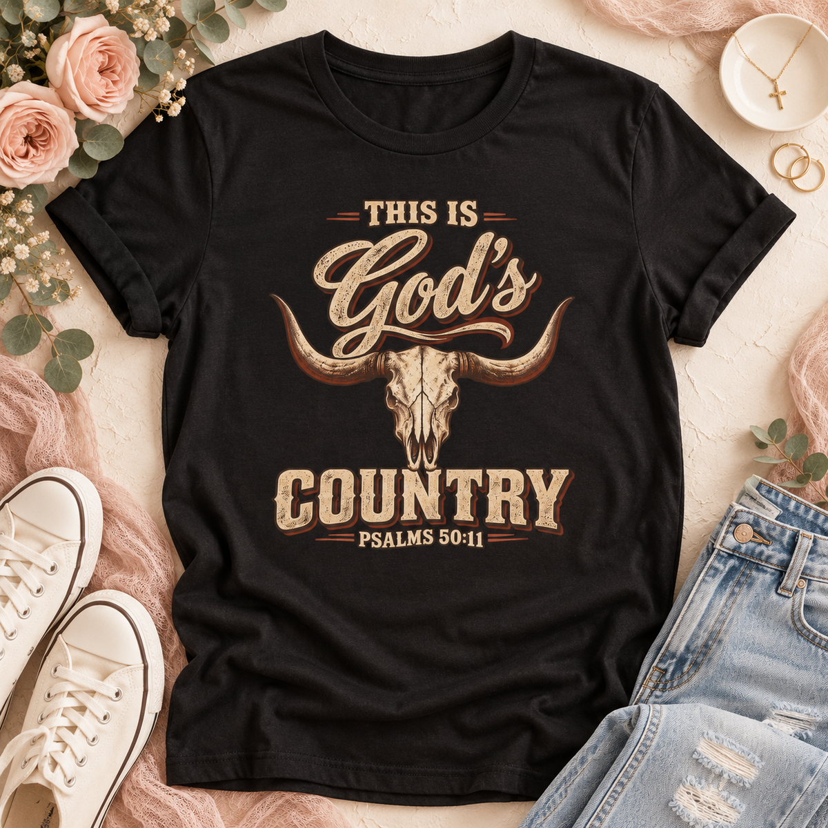 Black T-shirt with “This Is God’s Country” in distressed tan and brown lettering, a longhorn skull, and Psalms 50:11.