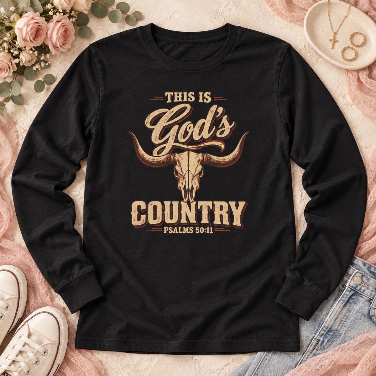 Black long-sleeve shirt with “This Is God’s Country” lettering, a longhorn skull, and Psalms 50:11.