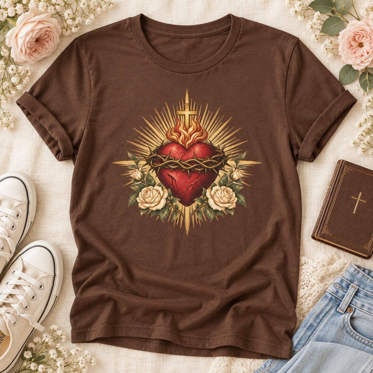 Brown Sacred Heart of Jesus T-shirt featuring a red heart, crown of thorns, cross, cream roses, and golden rays.