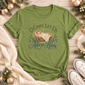 A green short-sleeve t-shirt with a Christmas-themed graphic reading 'O Come Let Us Adore Him' around an illustration of a baby in a manger.