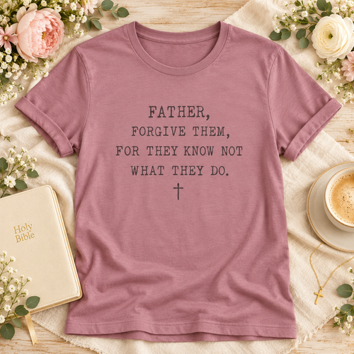 A mauve pink short-sleeve t-shirt with a printed black typographic message reading 'FATHER, FORGIVE THEM, FOR THEY KNOW NOT WHAT THEY DO.' 
