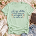 Mint T-shirt reading “Accept what is, let go of what was, have faith in what will be,” in dark blue lettering with floral accents.