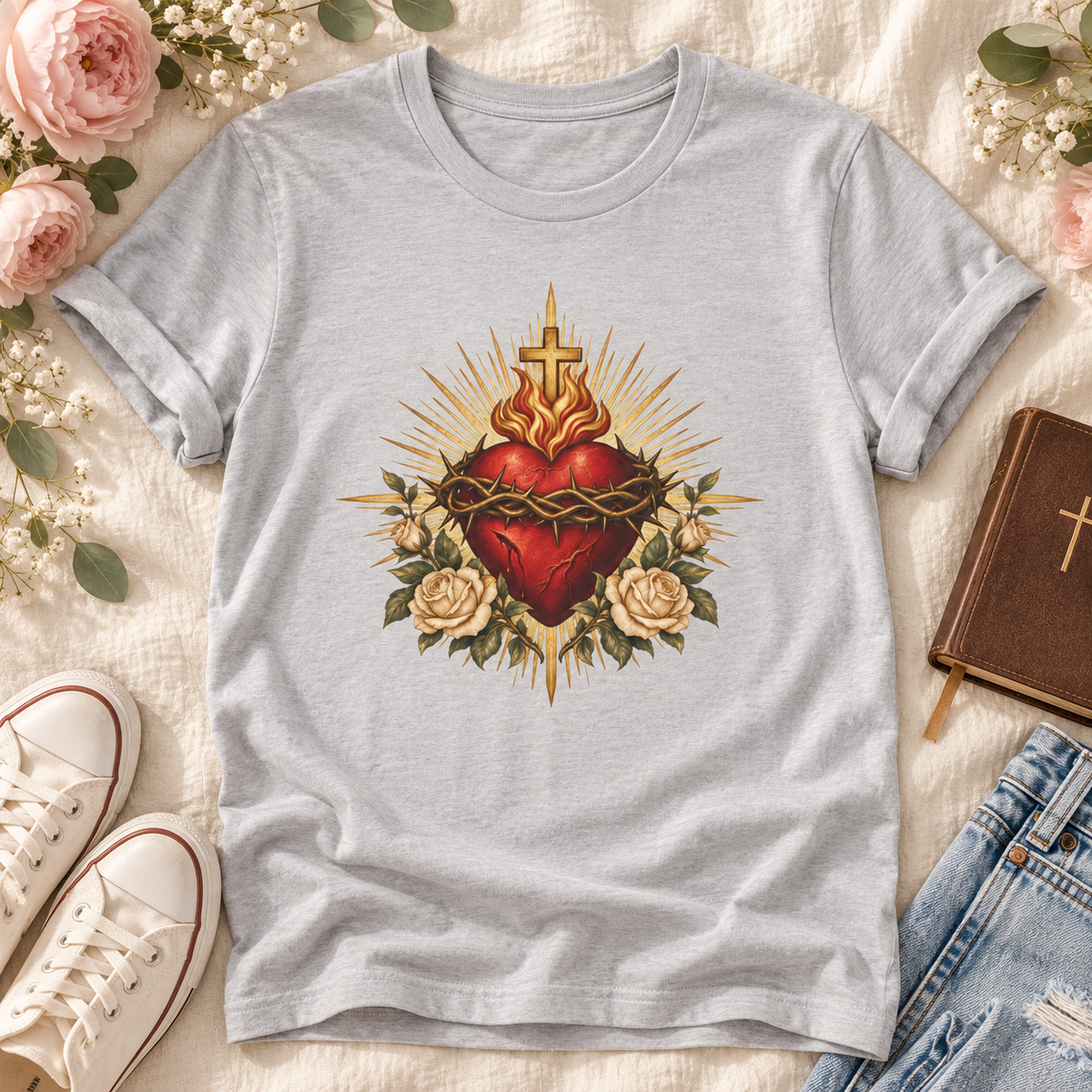 Silver Sacred Heart of Jesus T-shirt featuring a red heart, crown of thorns, cross, cream roses, and golden rays.