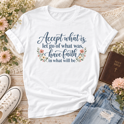 White T-shirt reading “Accept what is, let go of what was, have faith in what will be,” in dark blue lettering with floral accents.
