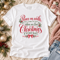 White colored short sleeve T-shirt with "Peace on earth will come to stay when we live Christmas Everyday" with Christmas greenery and a bow.